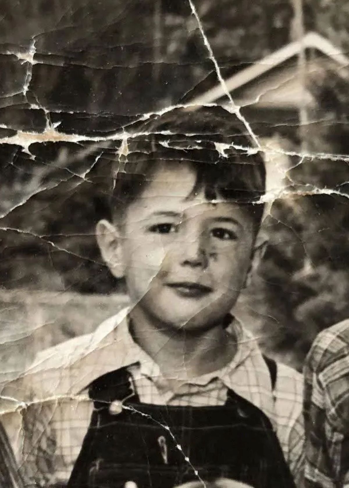Damaged portrait with missing sections before restoration