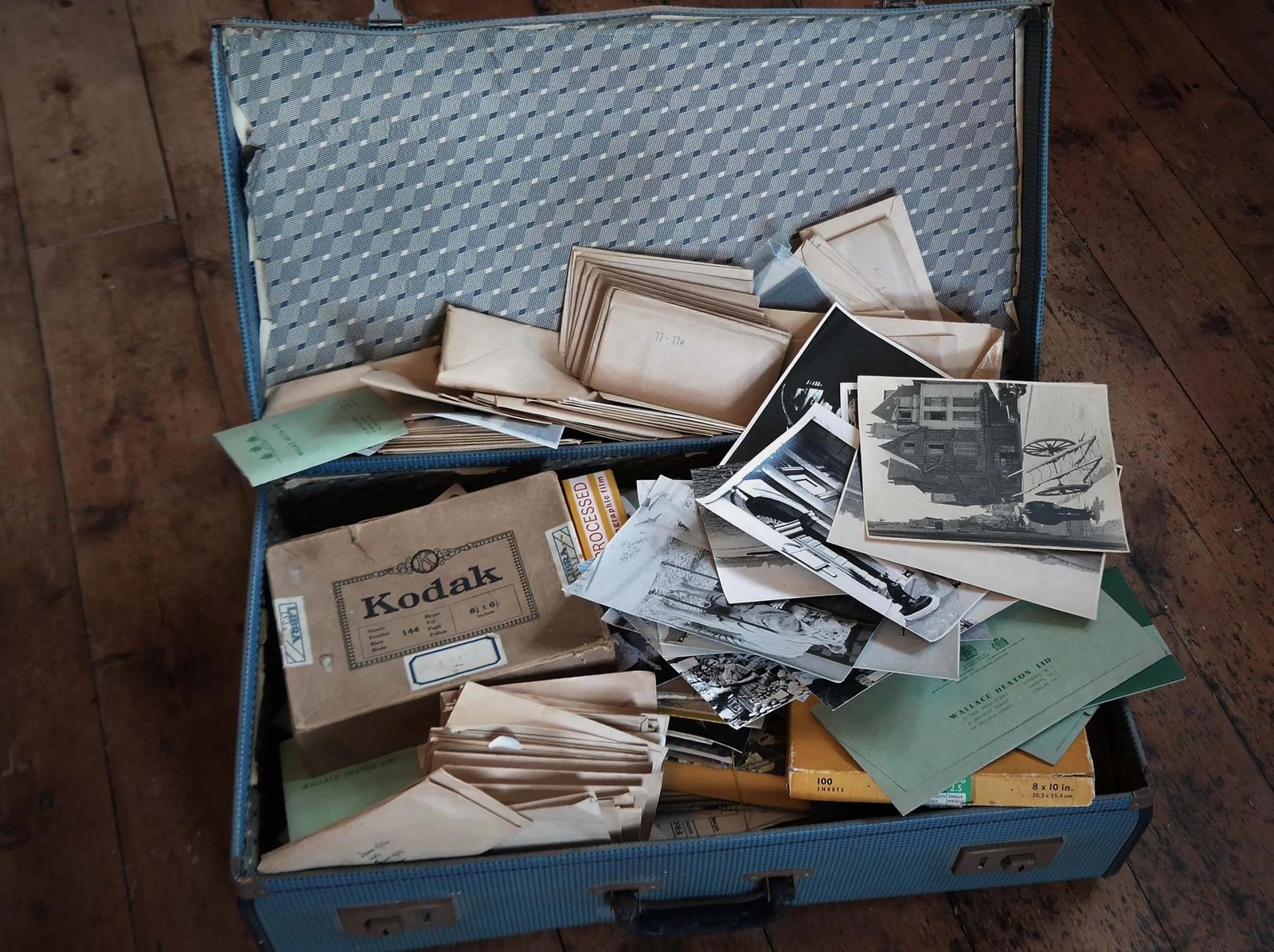 Organised photographic archive with labelled boxes, folders and preservation materials