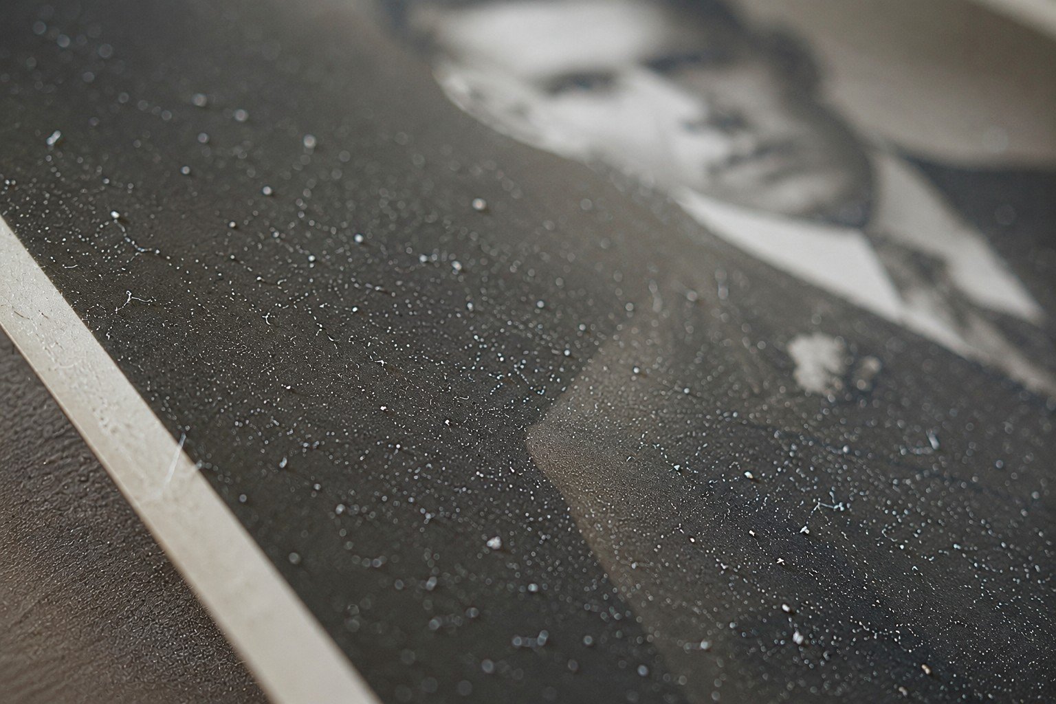 Dust and debris visible on an old photograph before scanning